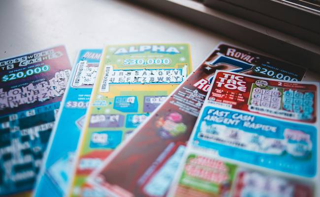 Canadian family using digital and printable coupons at grocery store checkout