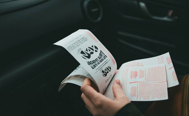 Canadian family organizing paper and digital coupons before a grocery store trip
