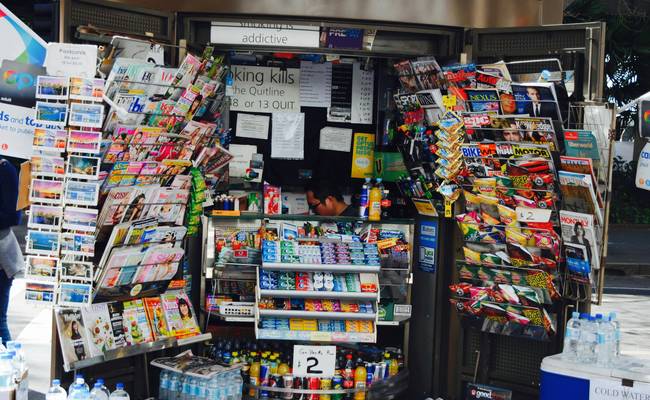 Canadian shopper stacking digital and printable coupons at grocery store checkout