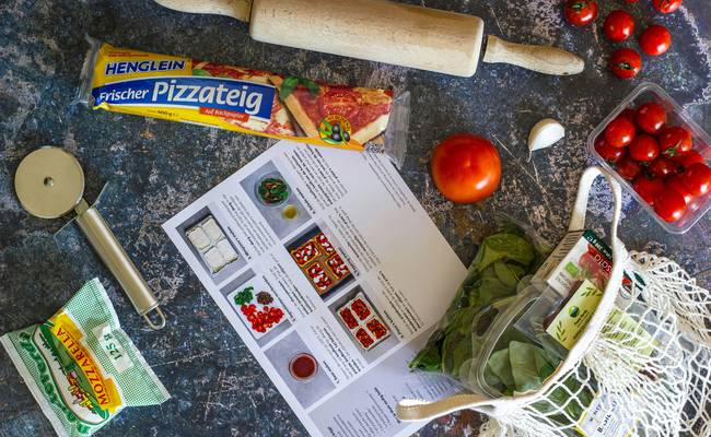 A Canadian family at home clipping and printing grocery coupons for a shopping trip