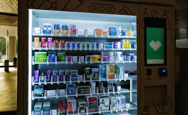 Canadian family using a mobile app and coupons at a pharmacy counter to save on prescriptions