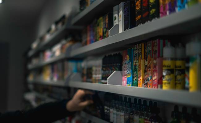 Shopper browsing pharmacy shelves at Rexall in Canada