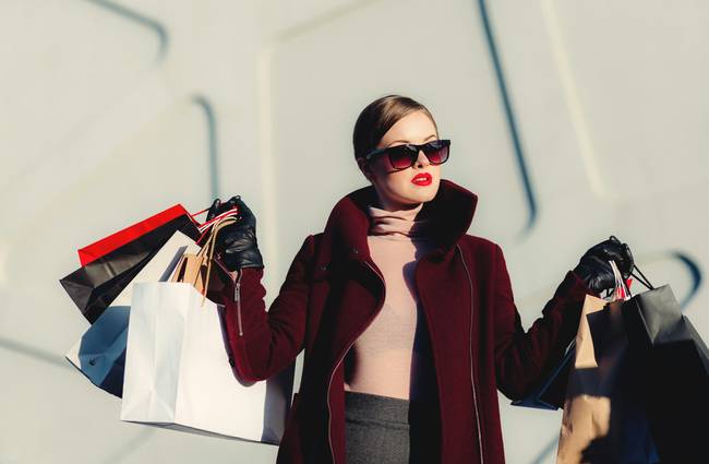 Canadian shopper using retail coupons at electronics and apparel stores