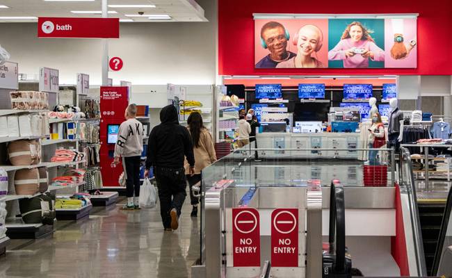 Canadian shoppers browsing aisles at a major retail store looking for coupon deals
