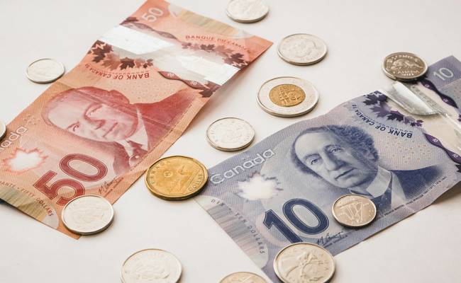 Canadian shoppers using coupons and CT Money at Canadian Tire checkout