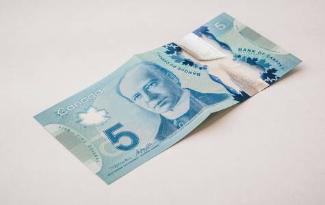 Canadian customer presenting a receipt at the Costco membership desk for a price adjustment