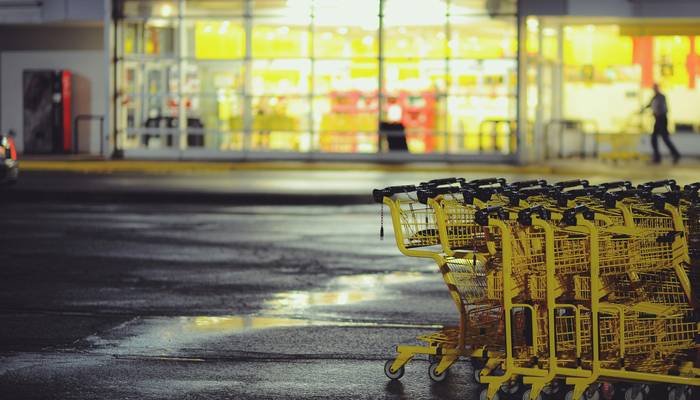 Happy Costco shoppers with full carts outside a Canadian Costco store