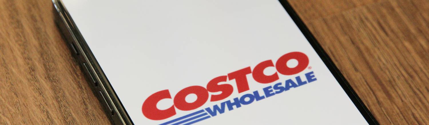 Costco shopper requesting a price adjustment at the customer service counter after price drop