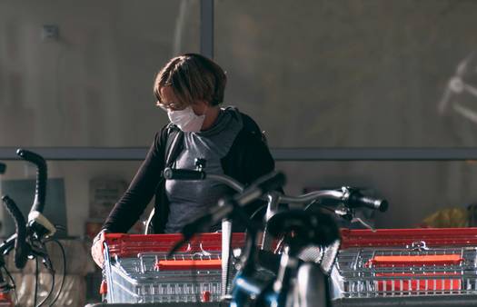 Canadian shopper with Kirkland Signature products in Costco cart, representing pro saving strategies