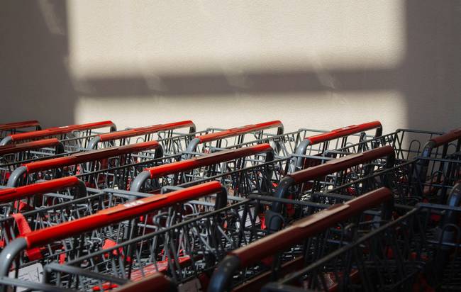 Shoppers entering a busy Costco warehouse with carts, illustrating Costco membership benefits and exclusive savings