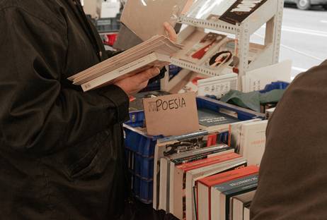 Canadian shopper organizing printable grocery coupons in a binder with a calculator