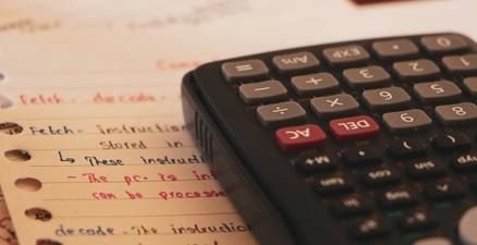 Calculator and coupons representing Canadian family's estimated savings