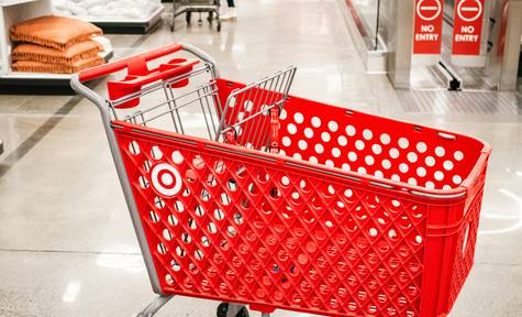 Canadian shopper presenting stacked coupons at grocery store checkout for big savings