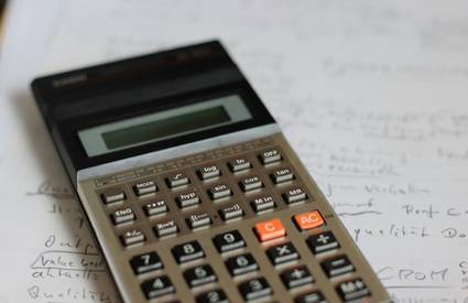 Canadian shopper using a coupon calculator to estimate yearly savings