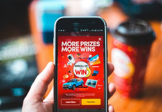 CT Money card and Triangle Rewards app being used at Canadian Tire checkout to earn bonus rewards