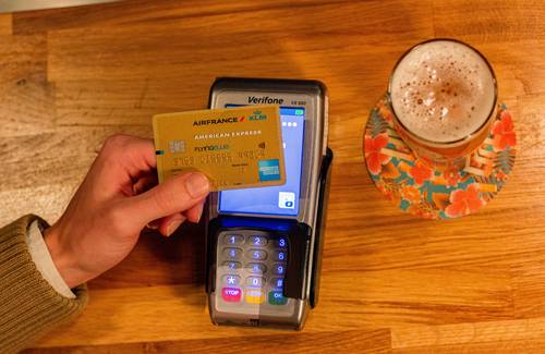 Canadian shopper scanning a digital coupon on their smartphone at grocery checkout