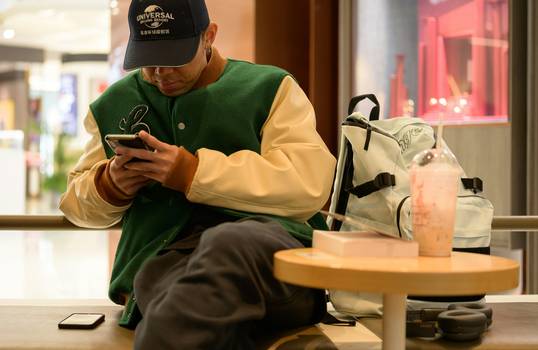 Shopper using a phone to redeem digital coupons at Loblaws grocery store