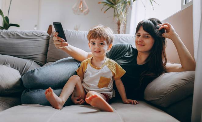 Canadian family organizing loyalty points together on a smartphone at home