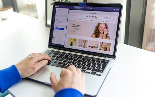 Canadian shopper browsing printable coupon websites at home