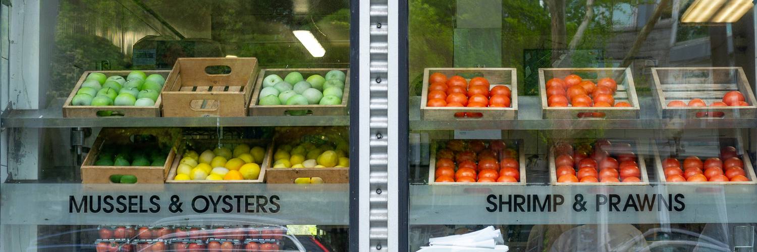 FreshCo grocery aisle with coupon signage highlighting weekly deals