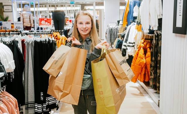 Canadian shopper using coupons and checking out at a Giant Tiger store in Canada