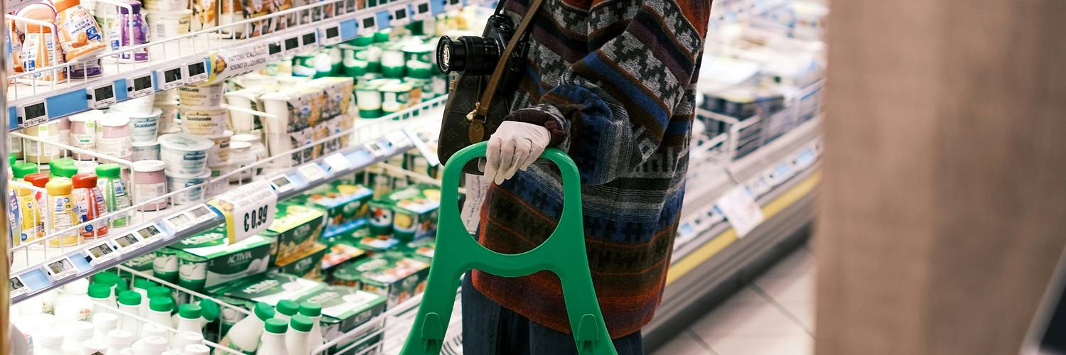 Shopper using coupons at grocery store