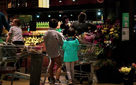 Canadian family scanning a loyalty app at grocery checkout for instant rewards