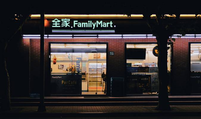 Canadian family using grocery loyalty apps and cards at supermarket checkout