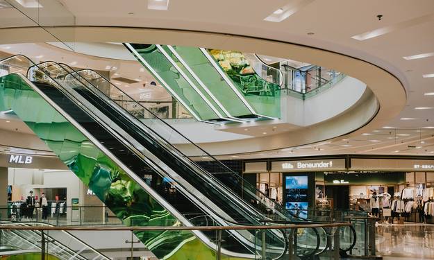 Bright, inviting modern Canadian department store scene with shoppers using coupons at checkout