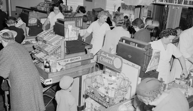 Canadian grocery shoppers using coupons at the checkout in a Loblaws store