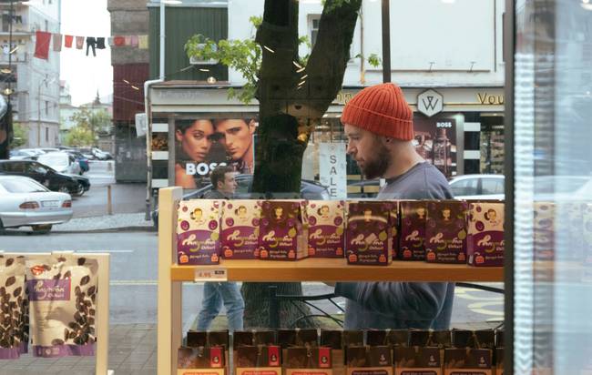 Happy Canadian shopper using multiple coupons at London Drugs in-store