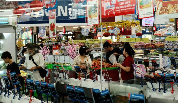 Shoppers saving money using coupons at Longo’s grocery store checkout