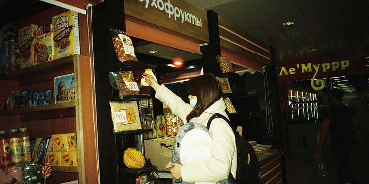 Shopper using digital coupons inside a Metro grocery store