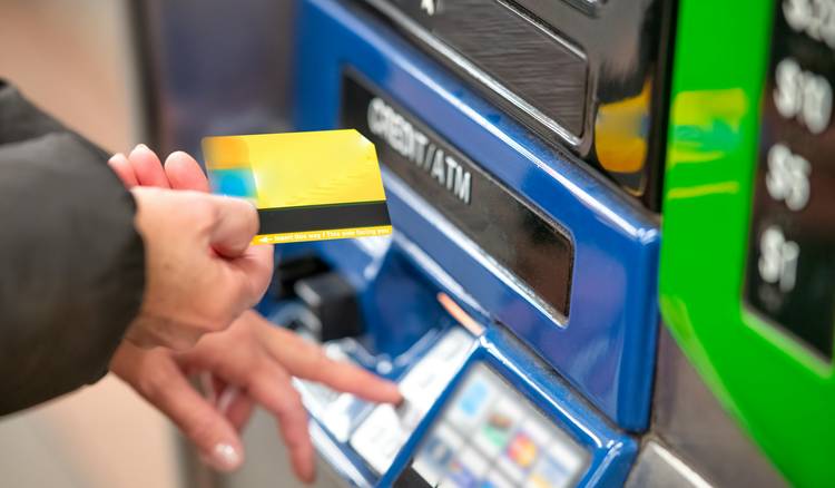 Customer scanning a Metro MOI card at checkout to earn points