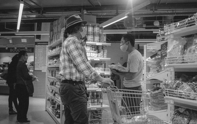 Canadian family using coupons at a No Frills grocery store checkout