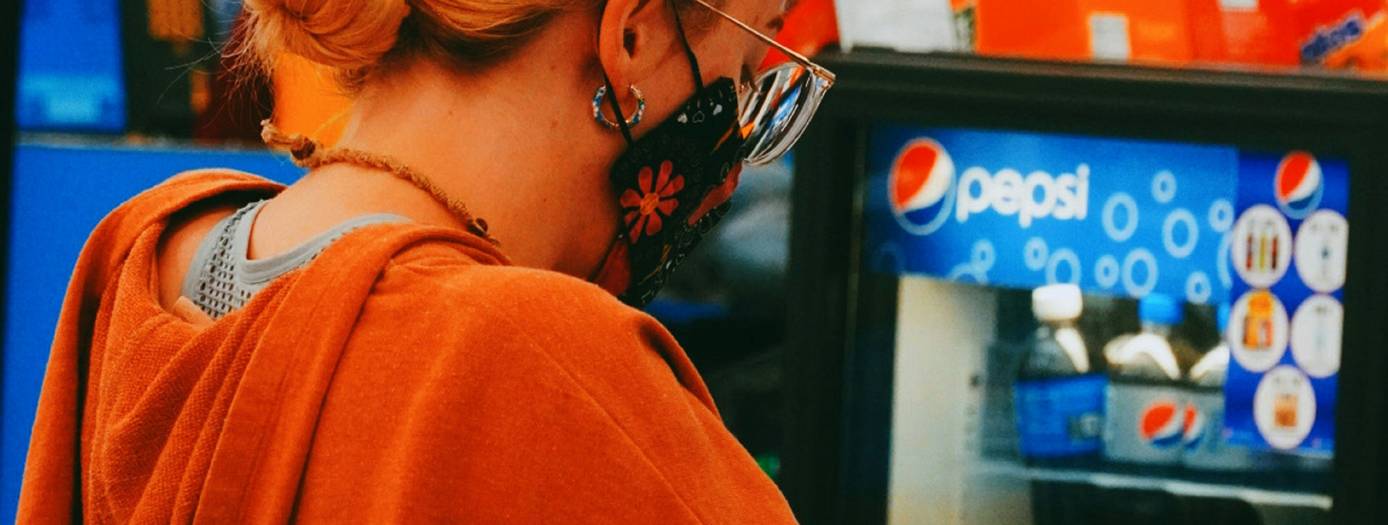 Shopper checking competitor flyer to request a No Frills Ad Match at checkout