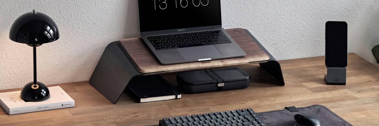 Modern desk with neatly arranged office supplies and a laptop