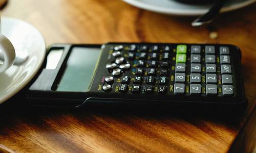 Visual of a calculator and PC Optimum app side-by-side for Canadian grocery coupon stacking math