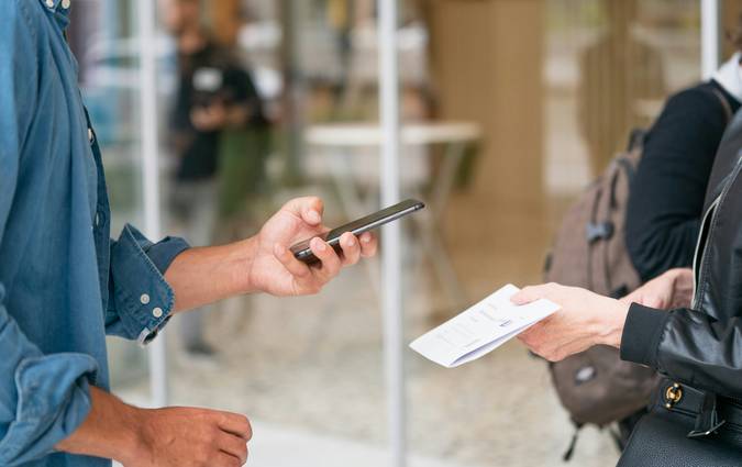 Canadian customer at a retail customer service counter requesting a price adjustment with a receipt