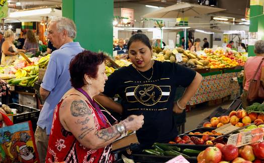 Canadian family discussing price matching tips while shopping for groceries