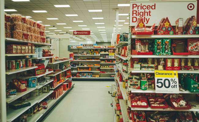 Canadian shopper presenting digital and paper coupons at Safeway grocery checkout