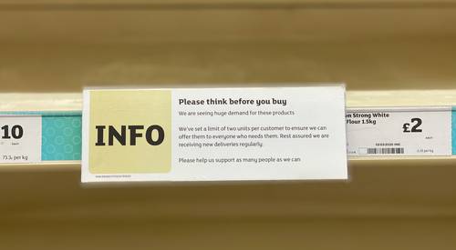 Safeway Canada store shelf with coupon policy signage