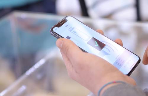Shopper scanning a Save.ca coupon on their phone at a Canadian grocery store checkout