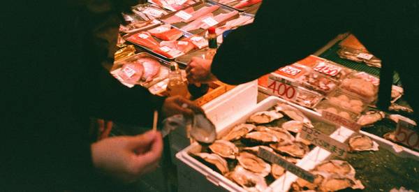 Cashier scanning coupons at a Save-On-Foods checkout counter in Canada