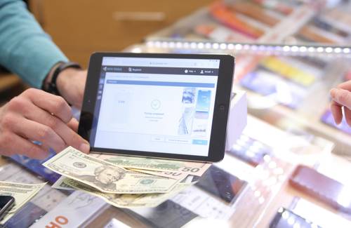 Shopper redeeming digital and printable coupons at Save-On-Foods checkout