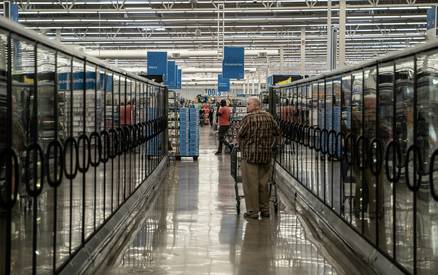 Shopper scans loyalty barcode at grocery till