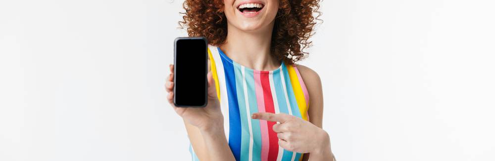 Canadian shopper loading Scene+ personalized offers on smartphone while holding paper coupons