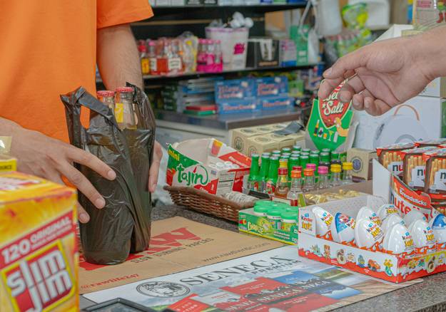 Happy Canadian shoppers using coupons at Shoppers Drug Mart