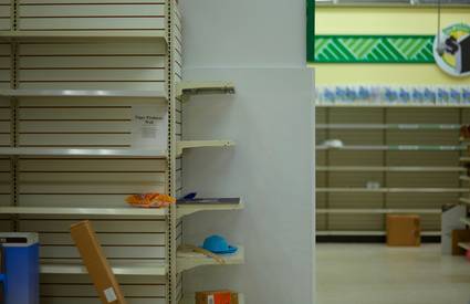 Shoppers Drug Mart staff restocking shelves before flyer launch
