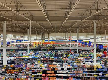 Sobeys shopper redeeming digital coupon and scanning Scene+ card at grocery checkout